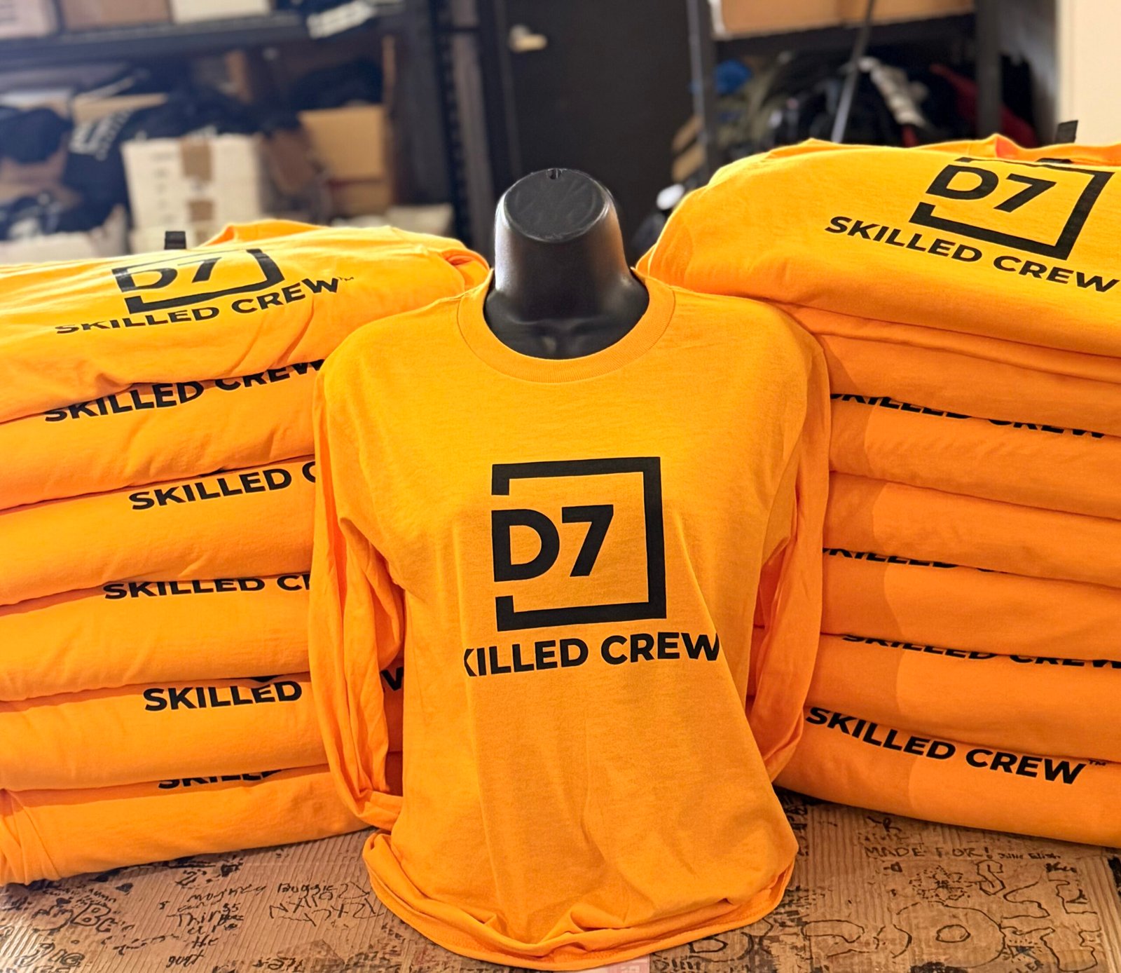 Branded safety-orange crew shirts prepared for a business team